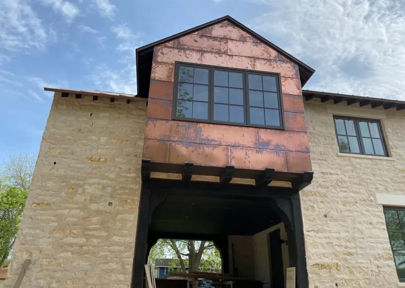 Copper metal panel facade on a stone building for Skylight Installation in Southchase