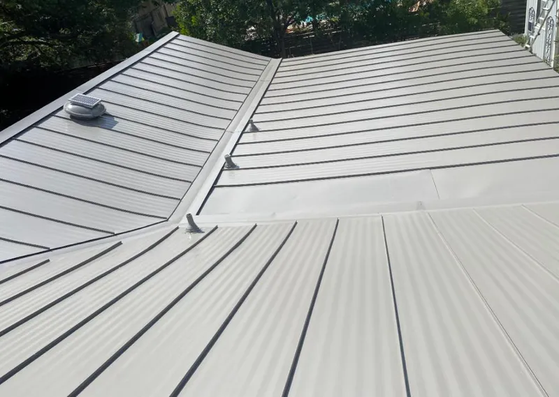Solar attic fan installed on a metal roof for Roof Ventilation in Southchase